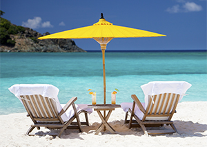 exotic beach with two empty beach chairs 